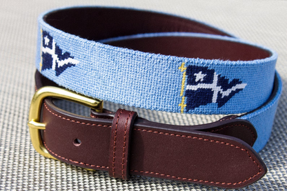 Custom needlepoint belt made by Fish Creek Brands. This image displays a personalized needlepoint belt with a yacht clubs signal flags. Additionally, the image displays the belt's dark brow leather tab and a solid brass buckle.